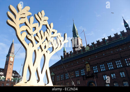 Copenhagen, Denmark. 8th December, 2014. The golden tree symbol (left) for  Copenhagen -  European Green Capital 2014. Photo background (right): Copenhagen City Hall. The European Green Capital is an initiative by the EU Commission. Copenhagen was awarded European Green Capital 2014 and at a ceremony  today the city handover this award to Bristol, UK. At the ceremony participates among other the EU Commissioner for the Environment, the Lord Mayor of Copenhagen and the Mayor of Bristol Credit:  OJPHOTOS/Alamy Live News Stock Photo