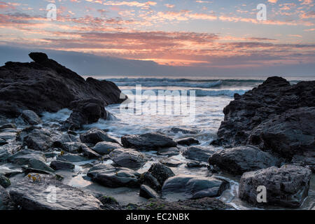 A stormy sunrise over Portholland beach on the south coast of Cornwall Stock Photo