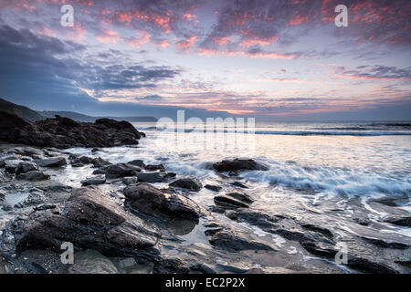 Stormy sunrise at Portholland beach on the south coast of Cornwall Stock Photo