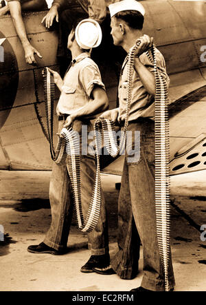 Ordnancemen loading belted cartridges into SBD-3 at NAS Norfolk, Va.  September 1942. (Navy) Stock Photo