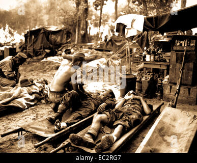 American medics treat casualties at an American portable surgical unit during the 36th Division drive on Pinwe, Burma.  November 12, 1944.  Sgt. W. Lentz.  (Army) Stock Photo