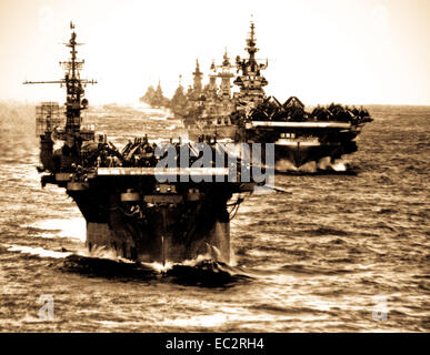 Task Group 38.3 in line as they enter Ulithi anchorage after strikes against the Japs in the Philippines.  USS LANGLEY, TICONDEROGA, WASHINGTON, NORTH CAROLINA, SOUTH DAKOTA, SANTA FE, BILOXI, MOBILE, and OAKLAND.  December 1944.  (Navy) Stock Photo