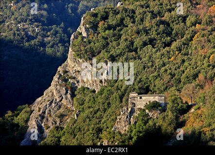 The church of the abandoned monastery of Agia Triada, hanging over a cliff, on the slopes of Mount Olympus, Pieria, Greece. Stock Photo