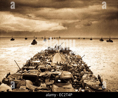 Columns of troop-packed LCIs trail in the wake of a Coast Guard-manned LST en route for the invasion of Cape Sansapor, New Guinea.  The deck of the LST is closely packed with motorized fighting equipment.  1944. PhoM1c. Harry R. Watson. (Coast Guard) Stock Photo