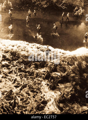Marines hit three feet of rough water as they leave their LST to take the beach at Cape Gloucester, New Britain.  December 26, 1943.  Sgt. Robert M. Howard.  (Marine Corps) Stock Photo