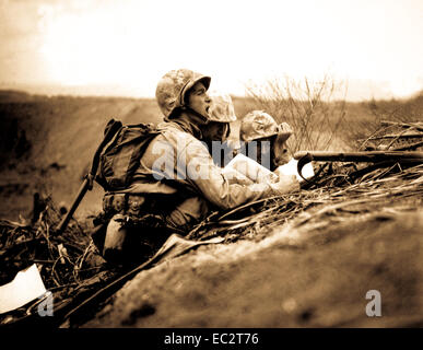 Observer who spotted a machine gun nest finds its location on a map so they can send the information to artillery or mortars to wipe out the position.  Iwo Jima, February 1945.  Dreyfuss.  (Marine Corps) Stock Photo
