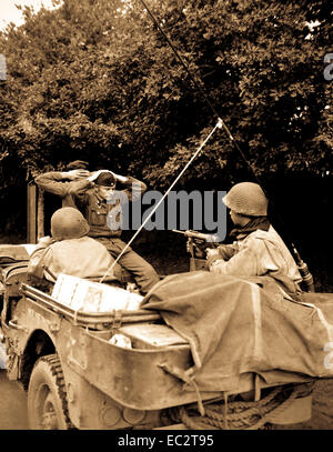 Two German prisoners of war are being taken to the 6th Div. POW Encampment for interrogation and searching.  There was 218 captured by the Free French Infantry and 6th Armored Div. troops.  Plouay, France.  August 28, 1944. Stock Photo