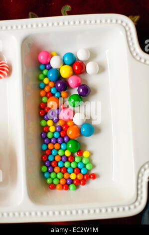 Colorful holiday gum balls on a white dish Stock Photo