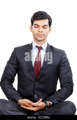Businessman meditating sitting crossed-legged on wall Stock Photo - Alamy