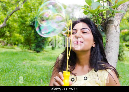 indian Beautiful lady park playing Bubble Wand Stock Photo