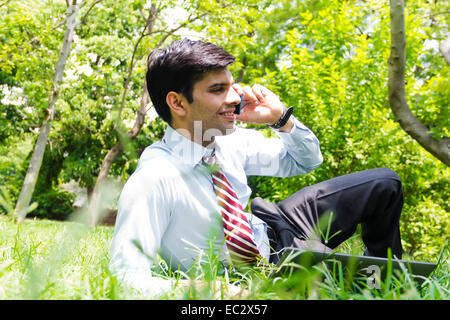 indian Business Man park talking phone Stock Photo