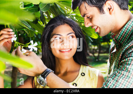 2 indian couple garden  Checking Flower Stock Photo