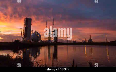 A United Launch Alliance Delta IV Heavy rocket with NASA’s Orion spacecraft mounted atop is seen during sunrise on Thursday, Dec. 4, 2014, at Cape Canaveral Air Force Station's Space Launch Complex 37, Florida. Orion launched onboard the rocket at 7:05 a.m. EST, Friday, Dec. 5, 2014 and orbited Earth twice, reaching an altitude of approximately 3,600 miles above Earth before landing. No one was aboard Orion for this flight test, but the spacecraft is designed to allow us to journey to destinations never before visited by humans, including an asteroid and Mars. Stock Photo