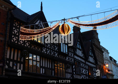 Shrewsbury, UK. 8th December, 2014. Christmas lights cross High Street, Shrewsbury, in front of historic black and white building facades as the town prepares for Christmas. In 1984, Shrewsbury was the location for a film adaptation of Charles Dickens' 'A Christmas Carol' starring George C. Scott as Scrooge. Credit:  John Gilbey/Alamy Live News Stock Photo