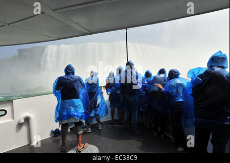 Tourists in raincoats on the tour boat Maid of the Mist, Horseshoe Falls, Niagara Falls, Niagara Falls, Ontario Province, Canada Stock Photo