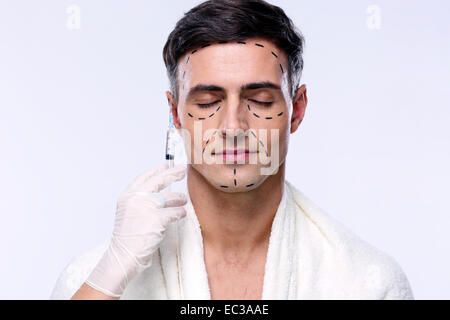 Man preparing for plastic surgery over gray background Stock Photo