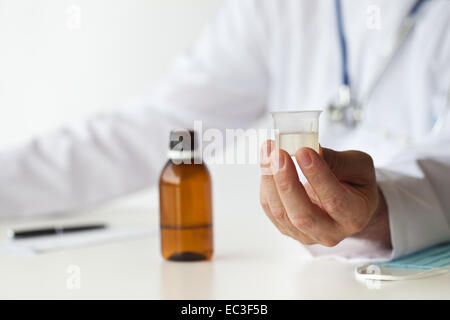 Doctor is giving a medicine in the consulting room. Stock Photo