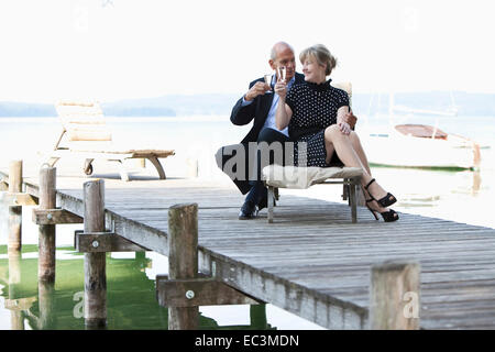 Older Couple drinking sparkling vine Stock Photo