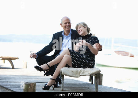 Older Couple drinking sparkling vine Stock Photo