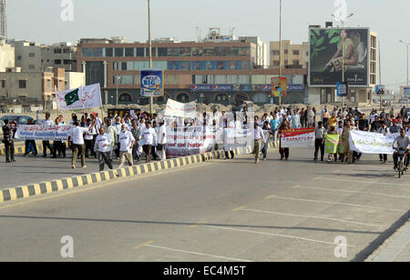 Citizens and NAB employees are holding awareness walk on the occasion of International Anti Corruption Day, passing through the road near Sea View organized by National Accountability Bureau in Karachi on Tuesday, December 09, 2014. Stock Photo