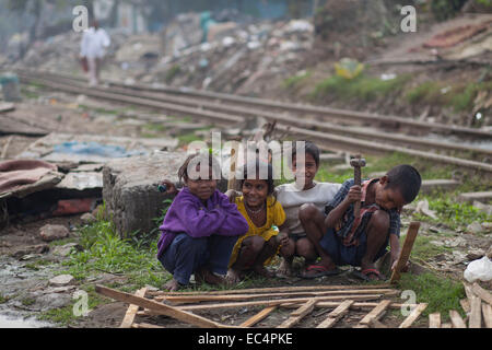 Dhaka, Bangladesh. 9th December, 2014. Slum children playing near rail line in Dhaka. A total of 3.5 million people are living in 4,000 slums in the Dhaka metropolitan area.Slums were evicted without any rehabilitation and now in winter they are suffering a lot. International Human Rights Day 2014 slogan  'Human Rights 365' by United Nations. Credit:  zakir hossain chowdhury zakir/Alamy Live News Stock Photo