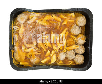 Top view of a large frozen TV dinner of penne pasta in a tomato sauce with meatballs in a black tray atop a white background. Stock Photo