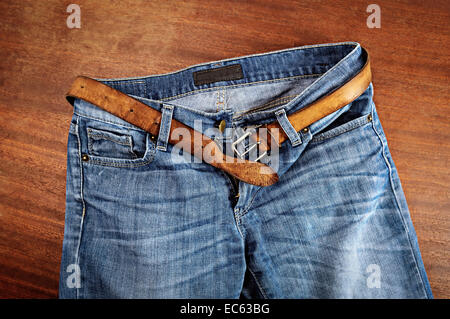 Detail of nice blue jeans with leather belt. Stock Photo