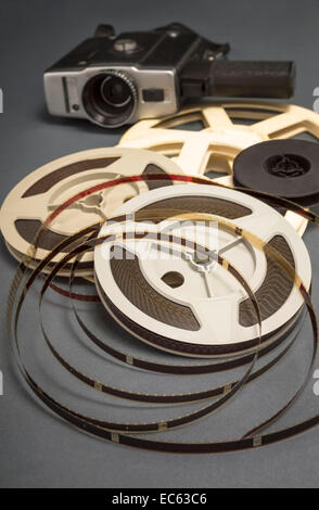 Still life of 8mm cine film reels and old movie camera. Shallow depth of field. Stock Photo