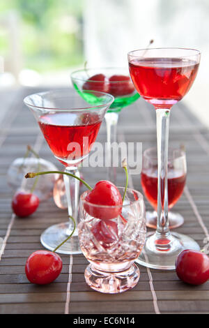 Cherry liquor in little vintage glasses Stock Photo