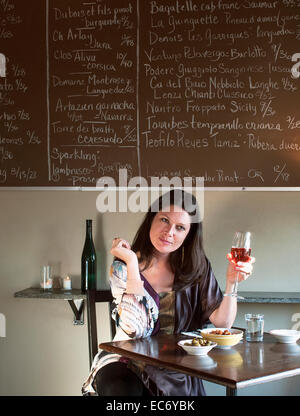 Elegant woman enjoying red wine in western restaurant Stock Photo - Alamy