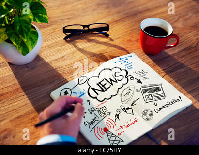 Man Drawing and Working on a News Concept Stock Photo