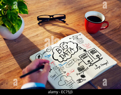 Businessman Writing on a Notebook About Big Data Stock Photo