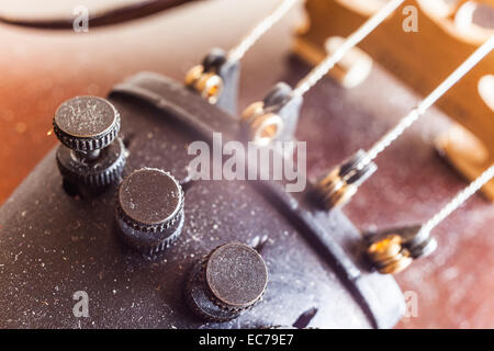 Micro tuners on violin for precise tuning, macro view. Stock Photo