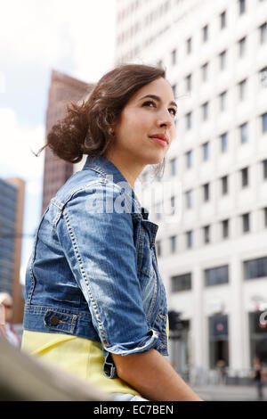 Germany, Berlin, portrait of young woman on city trip at Potsdam Square Stock Photo
