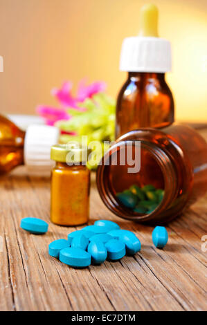 some bottles with different alternative remedies on a rustic wooden table Stock Photo