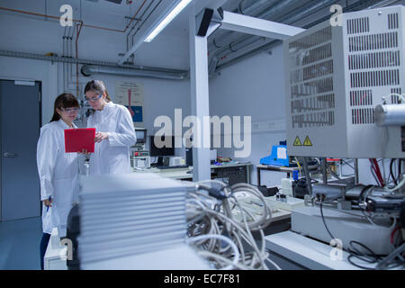 Two female technicans working together in a technical laboratory Stock Photo