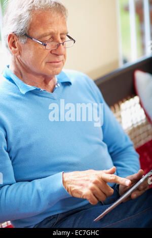 Senior man using digital tablet at home Stock Photo