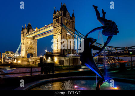 Girl With A Dolphin Fountain and Tower Bridge, London, England Stock Photo
