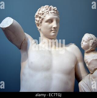 Hermes holding infant Dionysos. From Olympia, c340 BC. Hermes probably held grapes in his raised right hand, dangling them in front of the baby Dionysos. The statue was found in the temple of Hera, at Olympia, where Pausanias saw it in the 2nd century AD.  He said it is a work of Praxiteles, famous Athenian sculptor of the 4th century BC Stock Photo