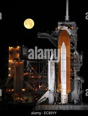 The Discovery space shuttle framed by a full moon. Its maiden flight was STS-41-D which launched on August 30, 1984. Over 27 years of service it flew 39 missions, gathering more flight time than any other spacecraft to date. Stock Photo