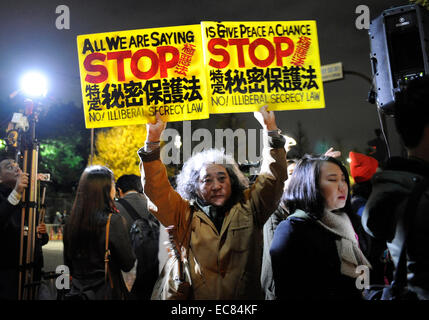 Tokyo, Japan. 10th Dec, 2014. A man holds placards during a demonstration against the controversial Special Secrecy Law in front of the Prime Minister's official residence in Tokyo, Japan, Dec. 10, 2014. The law came into effect on Wednesday. About 300 people took part in the demonstration. Credit:  Stringer/Xinhua/Alamy Live News Stock Photo