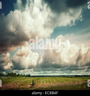 Empty country landscape with dramatic cloudy sky. Vintage toned square photo with instagram filter effect Stock Photo