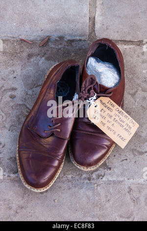 London, UK. 10th December, 2014. The shoes of hundreds of victims who died in Ireland, North and South during the Troubles are lined up opposite Downing Street as families demand that a proper investigation into over 3,600 deaths and 40,000 injuries on all sides, sets the truth free. PICTURED: The shoes of Stan Carberry, a father of six allegedly murdered on November 13th 1972 by the British Army, demand that the British government sets the truth free. Credit:  Paul Davey/Alamy Live News Stock Photo