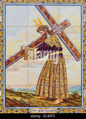 Seville - The ceramic tiled Christ with the cross by artist A. Chaves on the facade of square Plaza de Pilatos. Stock Photo