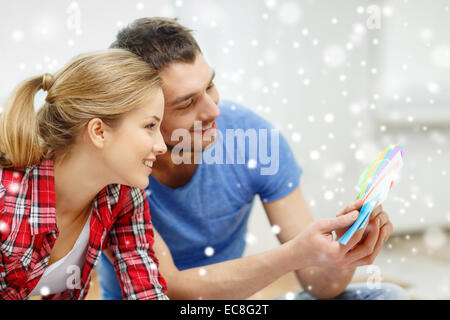 smiling couple selecting color from samples Stock Photo