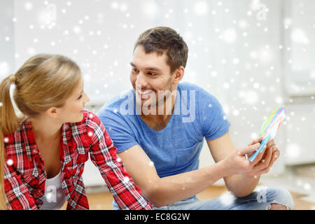 smiling couple selecting color from samples Stock Photo
