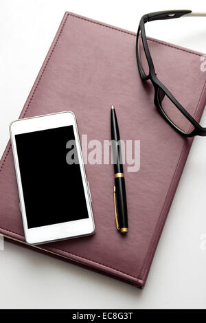 Mobile and office accessories on wood background, from above Stock Photo