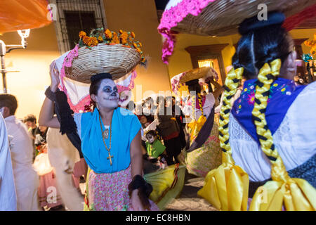 Costumed dancers at a Comparsa, or parade during the Day of the Dead Festival known in spanish as D’a de Muertos on October 31, 2014 in Oaxaca, Mexico. Stock Photo