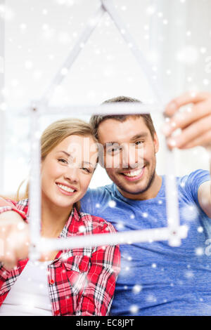 smiling couple with house made of measuring tape Stock Photo