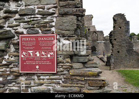 Danger do not climb on ruin sign in English and Welsh, Neath Abbey ruins, Neath, Glamorgan, Wales, UK Stock Photo